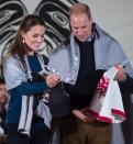 Draped in traditional First Nation blankets, Prince William, the Duke of Cambridge, and Kate, the Duchess of Cambridge, hold vests they were presented with for Prince George and Princess Charlotte during a welcoming ceremony at the Heiltsuk First Nation in the remote community of Bella Bella, B.C., on Monday September 26, 2016. THE CANADIAN PRESS/Darryl Dyck