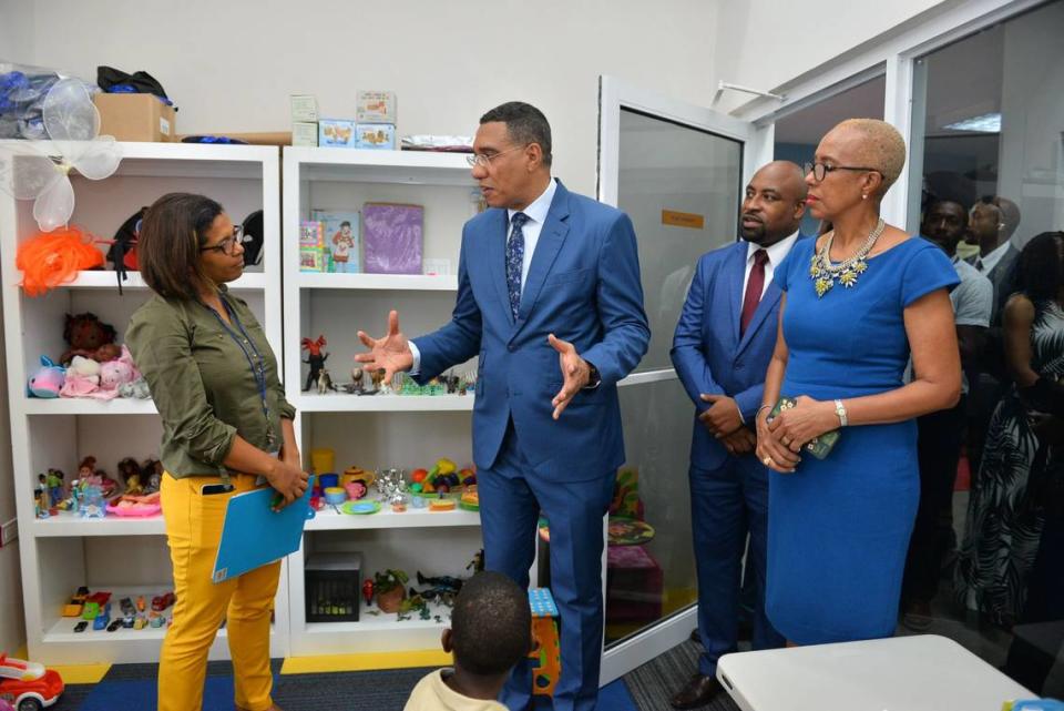 Jamaica Prime Minister Andrew Holness, center, on a visit with a child psychologist in the country where violence involving children is increasingly becoming a concern. Courtesy of Office of the Prime Minister