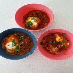 Plated eggs in sauce