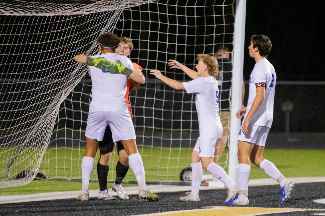 Andover teammates celebrate with senior goalkeeper Braden Rupp after he saved a penalty kick in overtime in the Class 5A quarterfinals against Maize South on Tuesday.