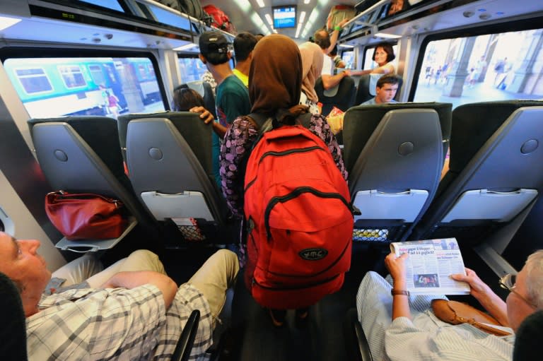 Migrants board the train travelling to Austria and Germany at the Eastern (Keleti) railway station in Budapest on August 31, 2015