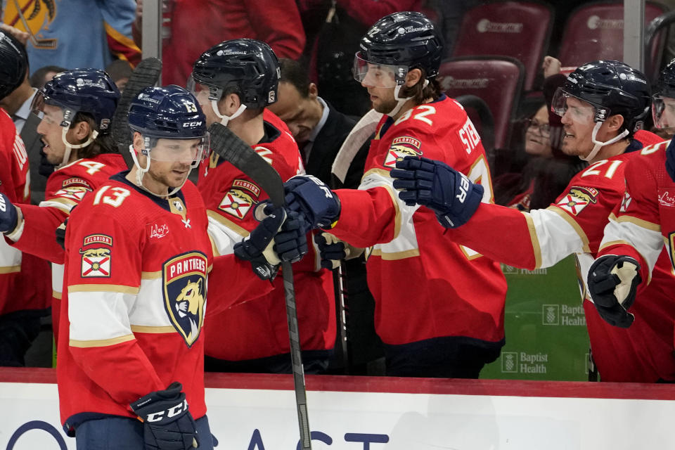 Florida Panthers center Sam Reinhart (13) is congratulated after scoring a goal during the first period of an NHL hockey game against the Dallas Stars, Wednesday, Dec. 6, 2023, in Sunrise, Fla. (AP Photo/Lynne Sladky)