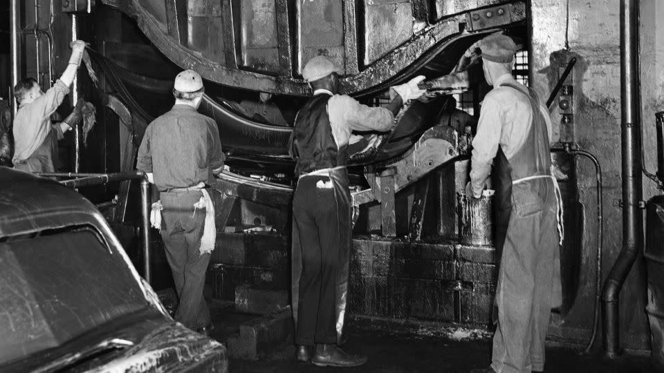 A 1946 photo  showing workers on a press forming in a Ford factory in Detroit. 
Black workers for decades were relegated to the lowest-paying jobs at auto factories, but fought to win greater access. - Intercontinentale/AFP/Getty Images