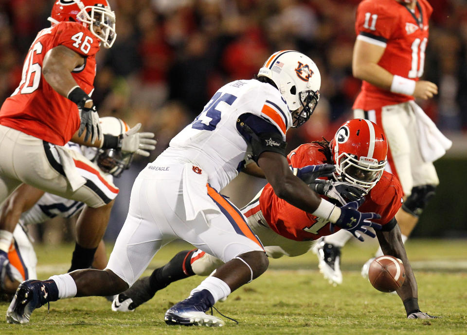 ATHENS, GA - NOVEMBER 12: Isaiah Crowell #1 of the Georgia Bulldogs fumbles the ball as he rushes toward Jonathan Evans #35 of the Auburn Tigers at Sanford Stadium on November 12, 2011 in Athens, Georgia. (Photo by Kevin C. Cox/Getty Images)