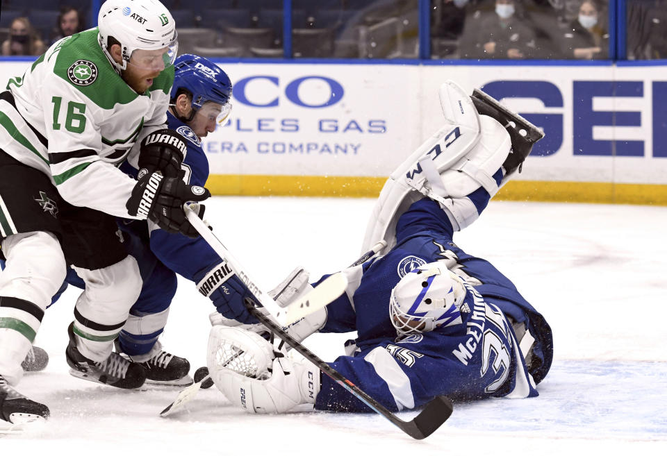 Tampa Bay Lightning goaltender Curtis McElhinney (35) makes a save on a shot from Dallas Stars center Joe Pavelski (16) during the third period of an NHL hockey game Friday, May 7, 2021, in Tampa, Fla. (AP Photo/Jason Behnken)