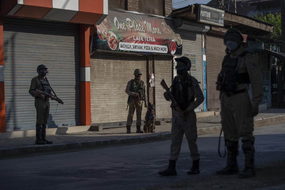 Paramilitary soldiers stands guard at an temporary check point on the first anniversary of India’s decision to revoke the disputed region’s semi-autonomy, in Srinagar, Indian controlled Kashmir, Wednesday, Aug. 5, 2020. Last year on Aug. 5, India’s Hindu-nationalist-led government of Prime Minister Narendra Modi stripped Jammu-Kashmir of its statehood and divided it into two federally governed territories. Late Tuesday, authorities lifted a curfew in Srinagar but said restrictions on public movement, transport and commercial activities would continue because of the coronavirus pandemic. (AP Photo/ Dar Yasin)