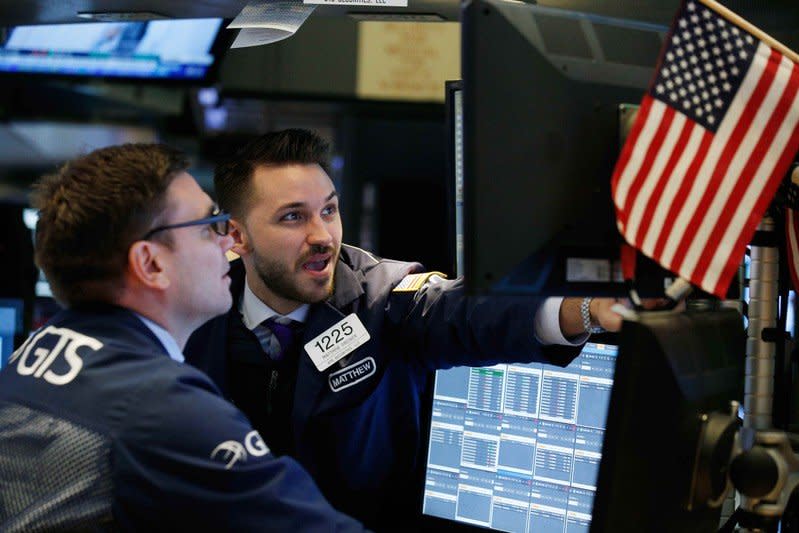 Traders work on the floor of the New York Stock Exchange ahead of the opening bell in New York, U.S., February 7, 2018. REUTERS/Brendan Mcdermid