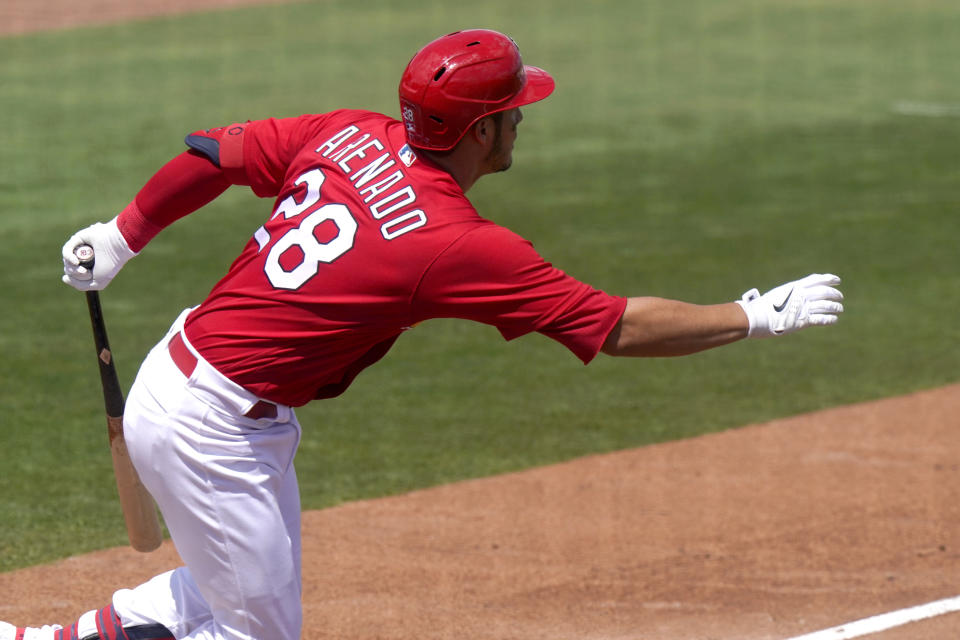 St. Louis Cardinals' Nolan Arenado (28) follows through on a single during the fourth inning of a spring training baseball game against the Washington Nationals, Monday, March 15, 2021, in Jupiter, Fla. (AP Photo/Lynne Sladky)