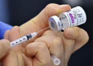 A nurse fills a syringe with the AstraZeneca COVID-19 vaccine at a health care center in Seoul Friday, Feb. 26, 2021. South Korea on Friday administered its first available shots of coronavirus vaccines to people at long-term care facilities, launching a mass immunization campaign that health authorities hope will restore some level of normalcy by the end of the year. (Jung Yeon-je /Pool Photo via AP)