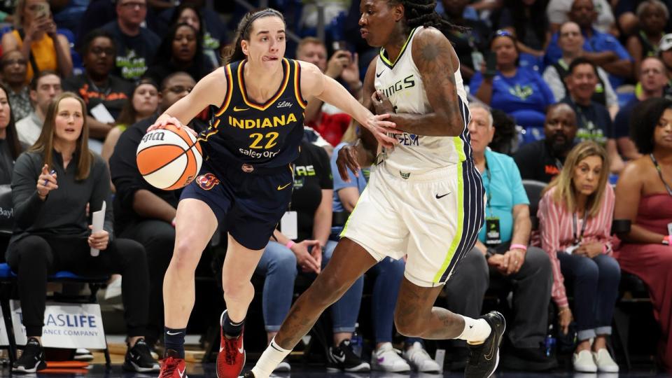 <div>ARLINGTON, TEXAS - MAY 03: Caitlin Clark #22 of the Indiana Fever drives to the basket against the Dallas Wings during the first quarter in the preseason game at College Park Center on May 03, 2024 in Arlington, Texas. (Photo by Gregory Shamus/Getty Images)</div>