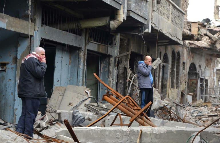 Iraqi men cover their noses as they inspect a site in Mosul where the bodies of jihadists killed during the battle for Iraq's second city lie in rubble-strewn alleys of the historic centre For three years, jihadists made life in Iraq's Mosul impossible. Now, six months after their defeat, even their corpses are polluting everyone's existence as no one wants to move them. Amid the rubble-strewn alleys overlooking the River Tigris, unburied human remains are rotting