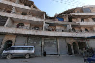 <p>Residents stand on the balconies of a damaged building in Manbij, in Aleppo Governorate, Syria, Aug. 9, 2016. (REUTERS/Rodi Said) </p>