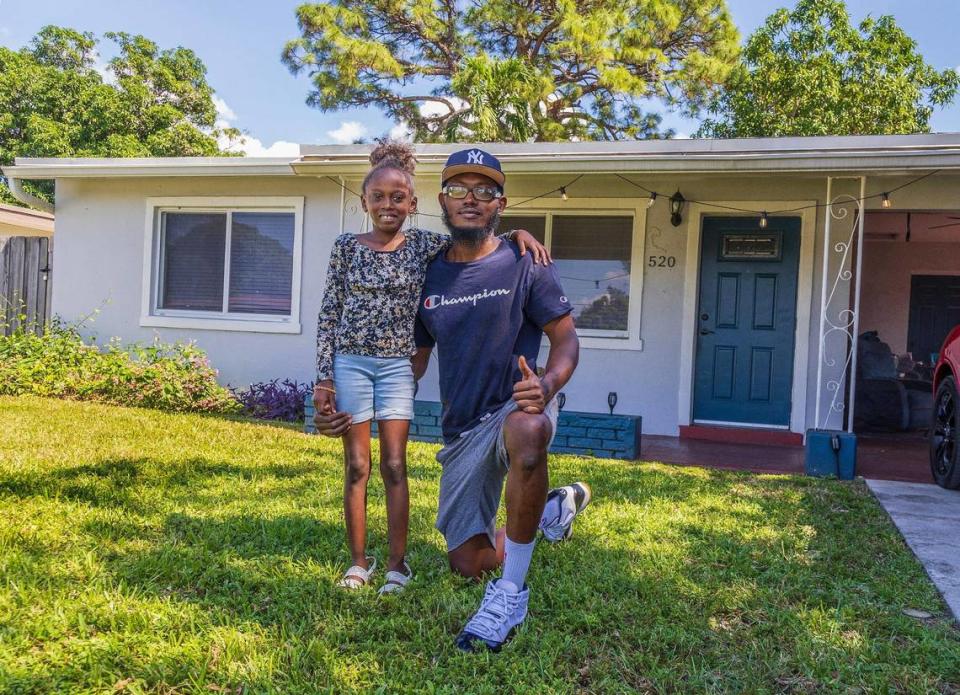 Jahshon Jones and his daughter Taylor Jones, 8, in front of their house in Fort Lauderdale, on Saturday, Oct. 21, 2023. Through the Fort Lauderdale Community Development Corp., Jones was able to rent the home for less than market rates.