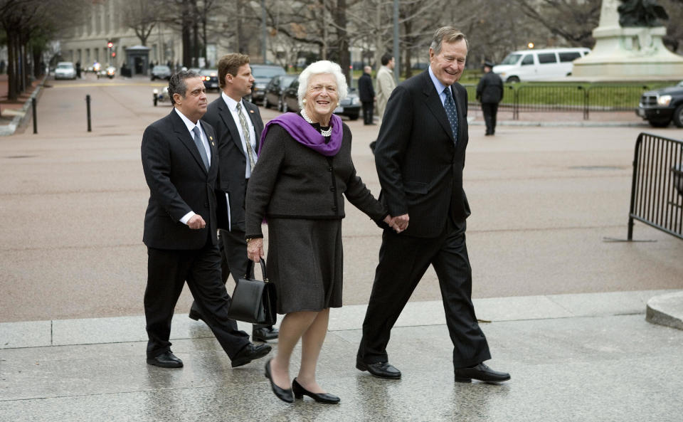 George H.W. and Barbara Bush walk down Pennsylvania Avenue to the White House on Jan. 1, 2007, in Washington, D.C.