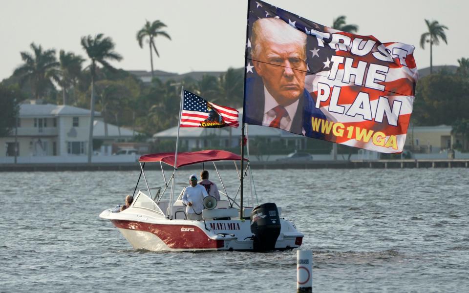 Supporters of Donald Trump behind his Mar-a-Lago estate in Florida on Saturday - AP