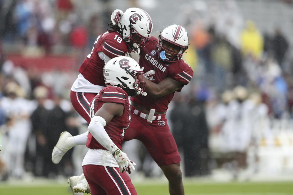 South Carolina defensive back Keenan Nelson Jr. (18) celebrates a defensive touchdown with defensive back DQ Smith (1) and defensive back Jalon Kilgore (24) during the second half of an NCAA college football game against Vanderbilt on Saturday, Nov. 11, 2023, in Columbia, S.C. (AP Photo/Artie Walker Jr.)