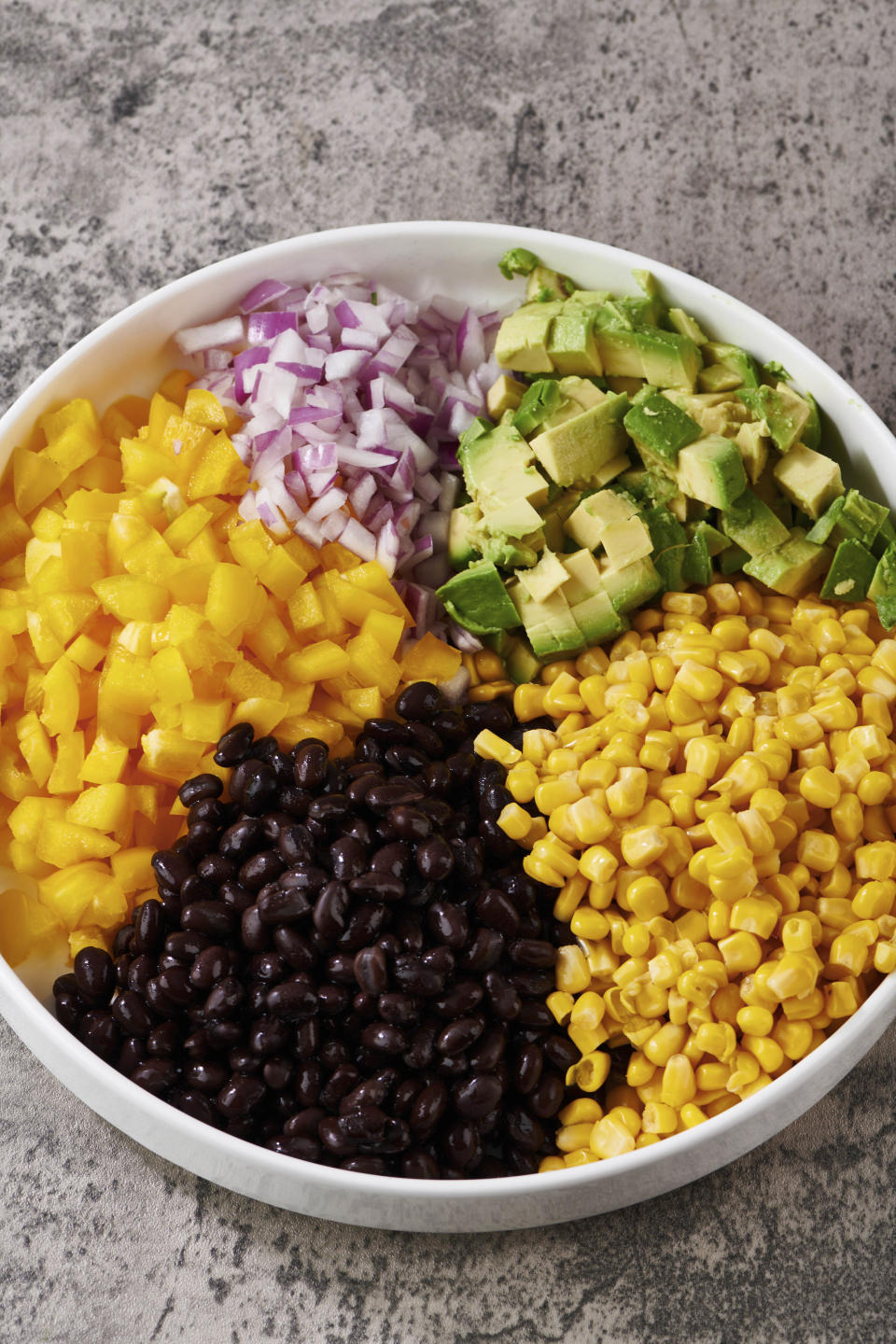 This image shows a vegetarian recipe for Black Bean and Corn Salad, a nourishing, protein-filled, meat-free meal for lunch. (Cheyenne M. Cohen via AP)