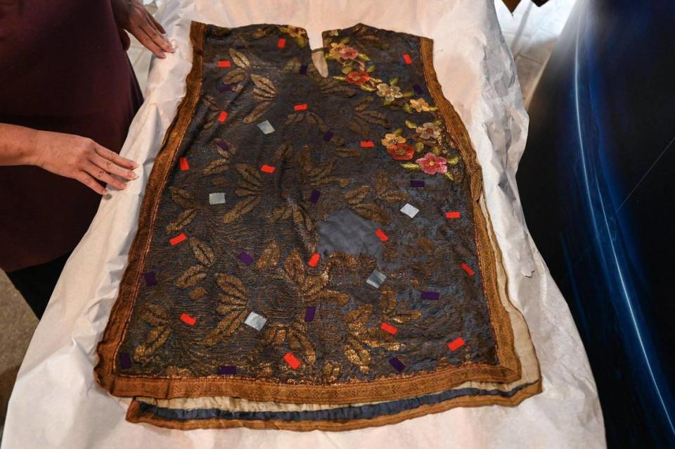 “This one is like a tabbard, but I think it was probably made from a 1920s dress. It’s lined with silk and it’s real metallic thread, which indicates to me that it’s before 1940,” said textile conservator Paige Myers. She was describing an original costume that will be on display at the Charlotte Museum of History new exhibit about Mary Cardwell Dawson.