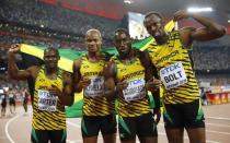 Jamaica's team (L-R) Nesta Carter, Asafa Powell, Nickel Ashmeade and Usain Bolt pose for photographers after winning the men's 4 x 100 metres relay final during the 15th IAAF World Championships at the National Stadium in Beijing, China, August 29, 2015. REUTERS/Kai Pfaffenbach