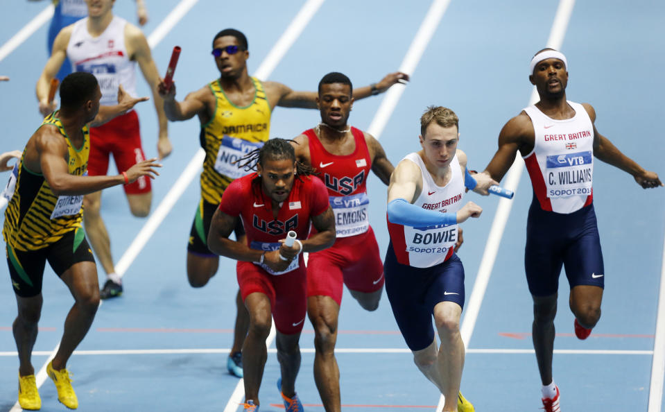 Relay teams of Jamaica, United States and Great Britain, from left, hand over batons in the men's 4x400m relay during the Athletics World Indoor Championships in Sopot, Poland, Sunday, March 9, 2014. Team of United States won the race. (AP Photo/Petr David Josek)