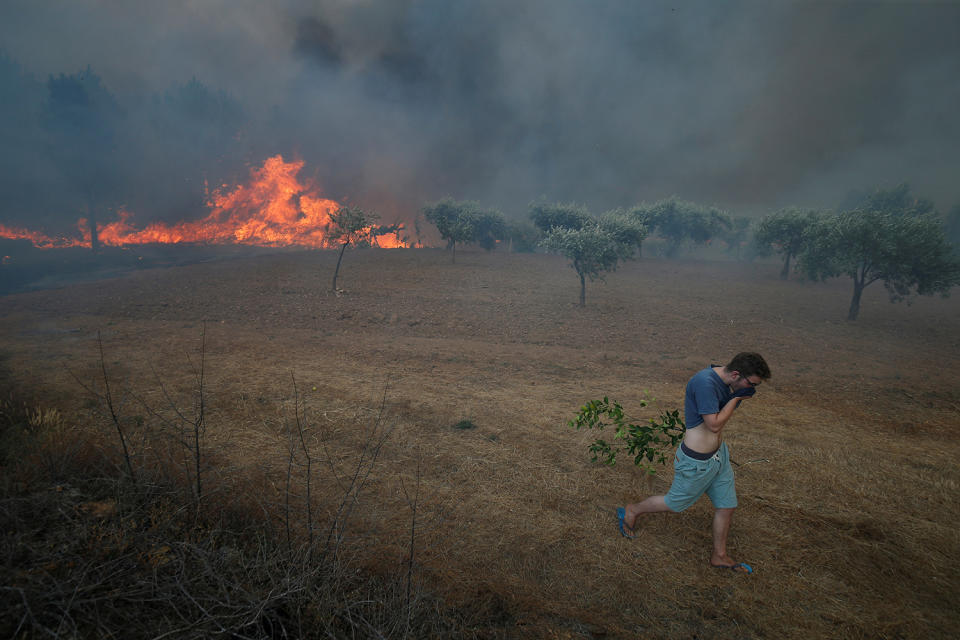 <p>A villager leaves a forest fire in the village of Brejo Grande, near Castelo Branco, Portugal, July 25, 2017. (Rafael Marchante/Reuters) </p>