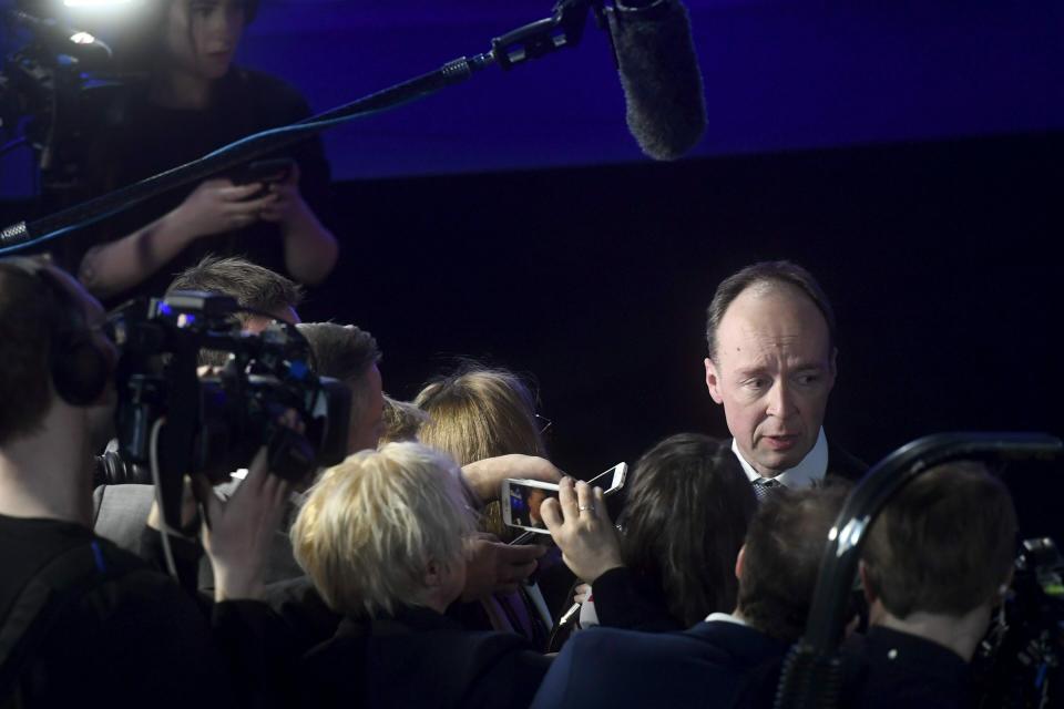 Chairman of The Finns Party Jussi Halla-aho surrounded by media at The Finns Party parliamentary election party in Helsinki, Finland on Sunday, April 14, 2019. (Vesa Moilanen/Lehtikuva via AP)