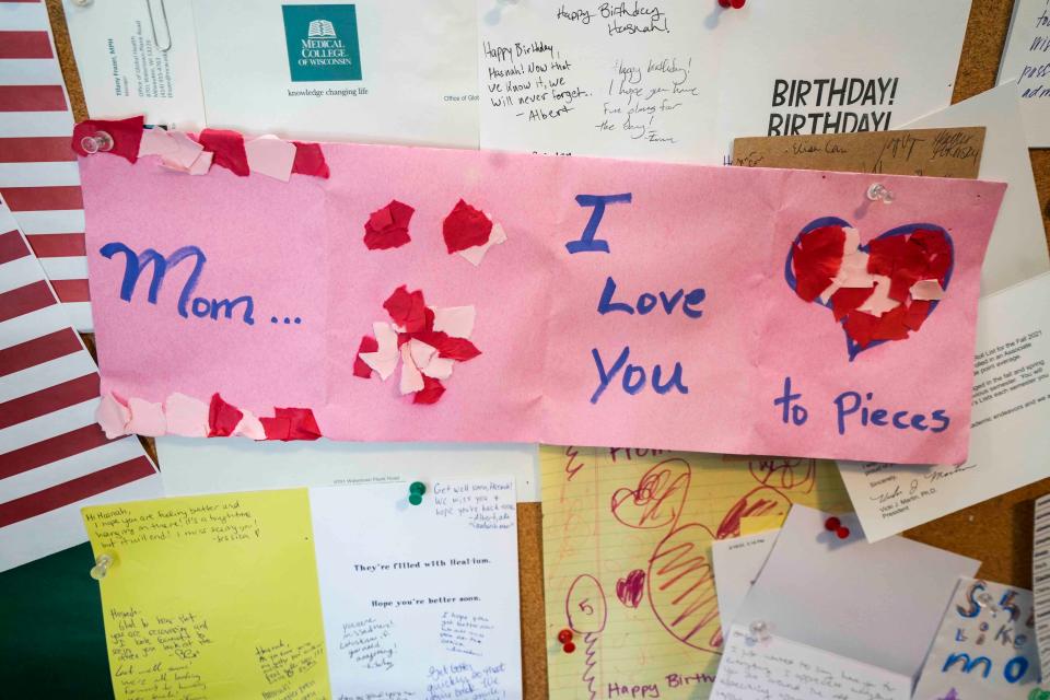 Artwork drawn by Hasnah Hussin's 6-year-old daughter hangs on her office wall at Catholic Charities in Milwaukee.