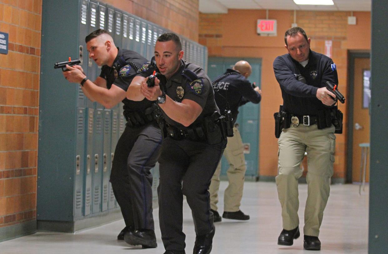 Police officers conduct an active-shooter drill in North Providence High School in 2017.