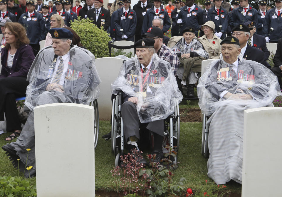 Canadian World War II veterans and other guests attend a ceremony at the Beny-sur-Mer Canadian War Cemetery in Reviers, Normandy, France, Wednesday, June 5, 2019. A ceremony was held on Wednesday for Canadians who fought and died on the beaches and in the bitter bridgehead battles of Normandy during World War II. (AP Photo/David Vincent)