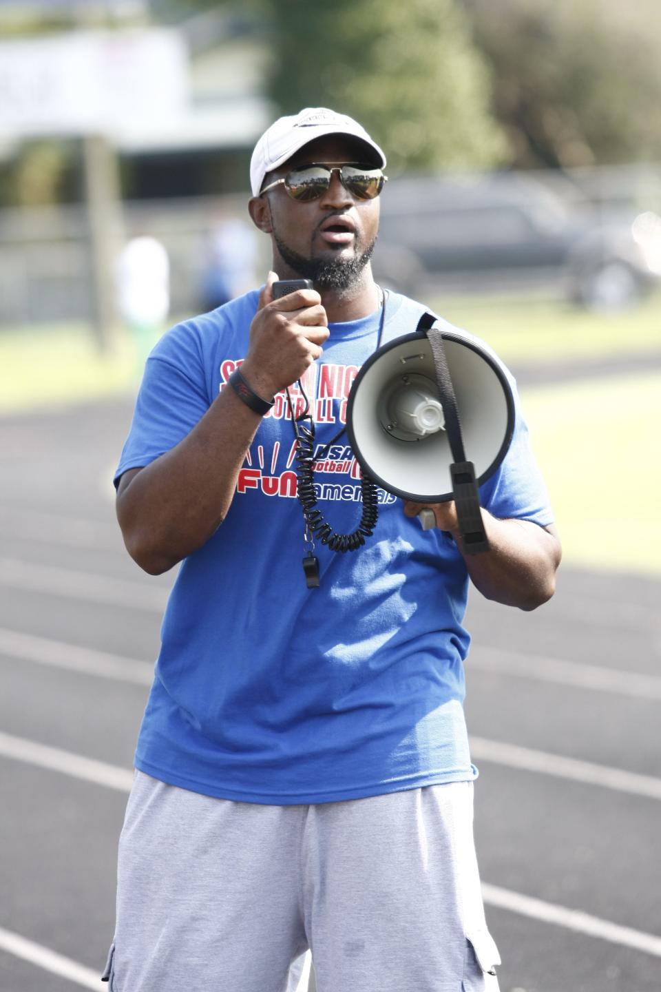 Coach Antwan Nicholas instructs the kids at a 2012 football camp hosted by Atlanta Falcons linebacker and Jacksonville native Stephen Nicholas at Mallison Park on Jacksonville's Westside.