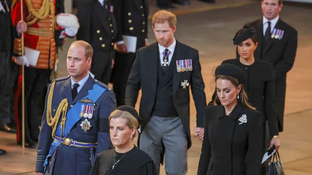 PHOTO: Prince William, Kate, Princess of Wales, Prince Harry and Meghan, Duchess of Sussex walk as the procession with the coffin of Britain's Queen Elizabeth arrives at Westminster Hall in London, Sept. 14, 2022. (Phil Noble/Pool Photo via AP)