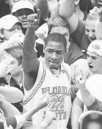 Florida State\'s Tim Pickett (center) is surrounded by fans after the Seminoles\' 90-81 win over North Carolina. AP Photo.