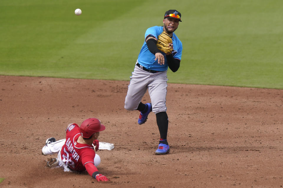 Washington Nationals' Tres Barrera (38) is out at second as Miami Marlins second baseman Isan Diaz throws to first for a double play during the third inning of a spring training baseball game, Wednesday, March 3, 2021, in West Palm Beach, Fla. Diaz is competing with fellow prospect Jazz Chisholm for the second base job. (AP Photo/Lynne Sladky)