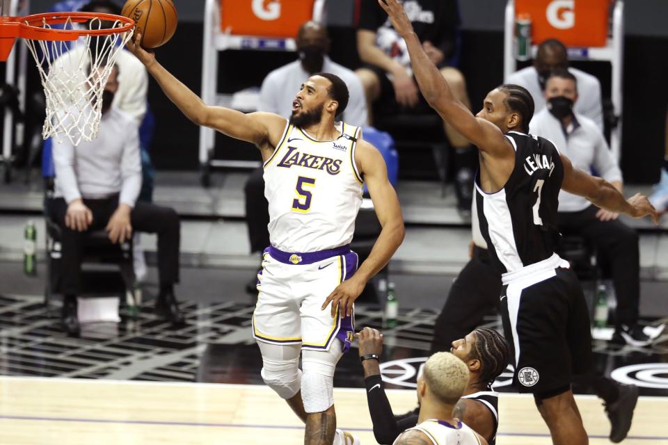 Lakers guard Talen Horton-Tucker scores while guarded by Clippers forward Kawhi Leonard.