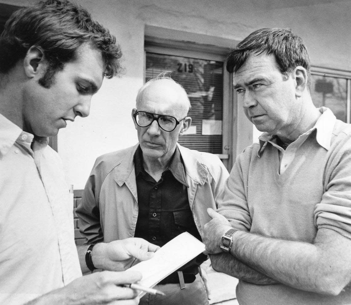 A 1980 photo shows assistant city editor Ted Vaden (left), editor Claude Sitton (middle), and publisher Frank Daniels Jr. conferring after a fire at the News & Observer offices in Raleigh.