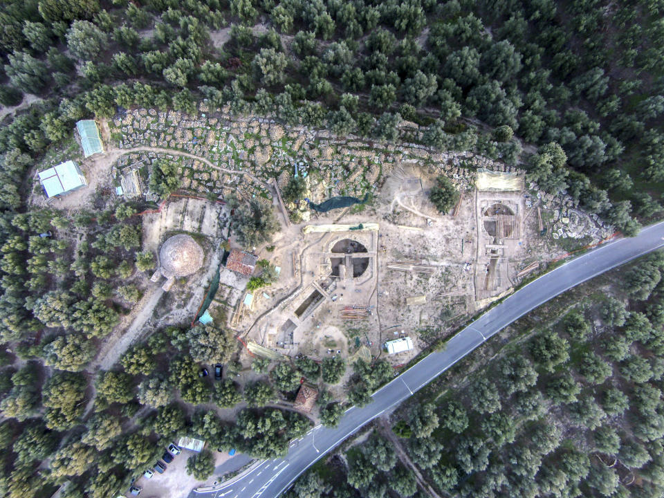 In this undated photo provided by the Greek Culture Ministry on Tuesday, Dec. 17, 2019, an aerial view is seen of two 3,500-year-old tombs, center and right, discovered near the southwestern Greek town of Pylos, together with one found decades ago, left. The ministry said American archaeologists have discovered two monumental royal tombs dating 3,500 years back, near a large Bronze Age palace that featured in Homer's Odyssey. Recovered grave goods included a golden seal ring and a golden Egyptian amulet. (Greek Culture Ministry via AP)