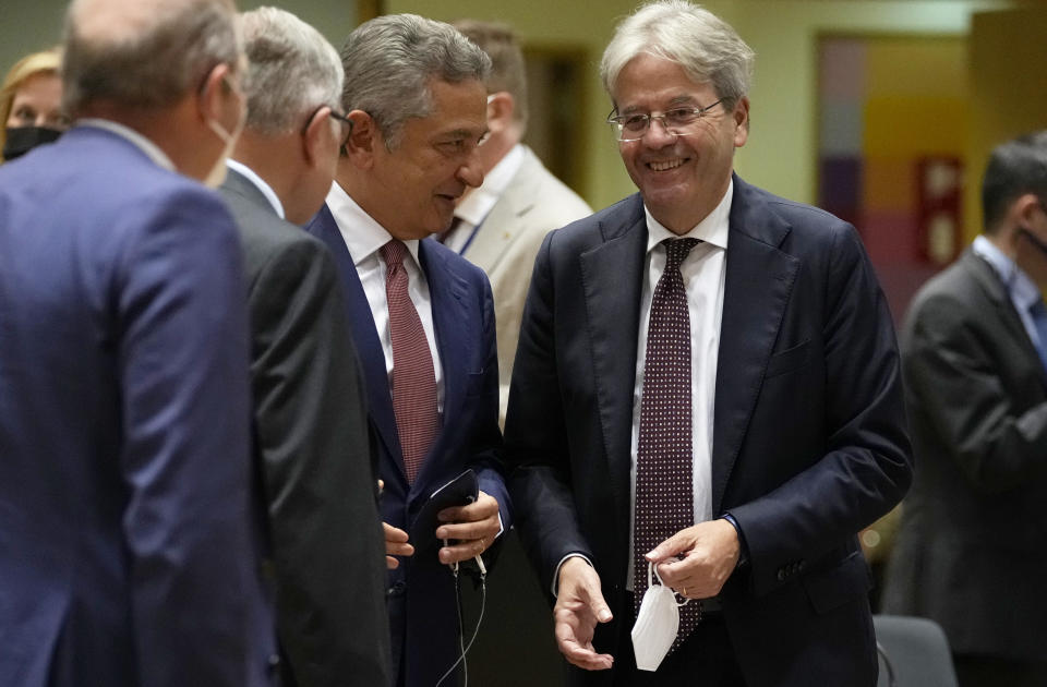 European Commissioner for Economy Paolo Gentiloni, second right, speaks with Fabio Panetta, Member of the Executive Board of the ECB, third left, during a meeting of the eurogroup finance ministers at the European Council building in Brussels on Monday, July 12, 2021. (AP Photo/Virginia Mayo)