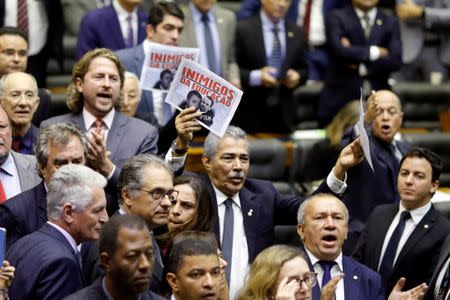 Opposition members of the lower chamber of Brazil's Congress protest against Brazil's Education Minister Abraham Weintraub (not pictured) during a session at the plenary of the Chamber of Deputies in Brasilia, Brazil May 15, 2019. REUTERS/Adriano Machado