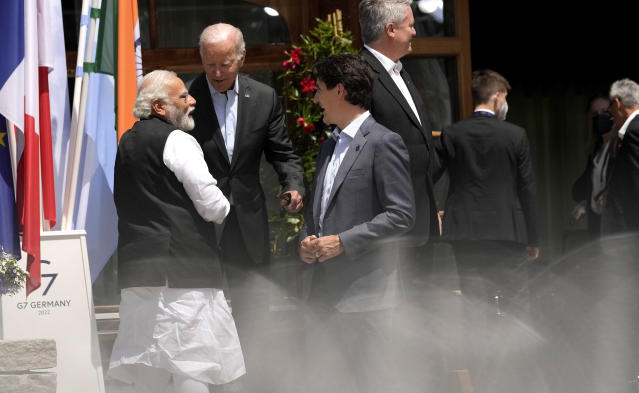 India's Prime Minister Narendra Modi, left, speaks with U.S. President Joe Biden, second left, and Canada's Prime Minister Justin Trudeau after a group photo of G7 leaders and Outreach guests at Castle Elmau in Kruen, near Garmisch-Partenkirchen, Germany, on Monday, June 27, 2022. The Group of Seven leading economic powers are meeting in Germany for their annual gathering Sunday through Tuesday. (AP Photo/Markus Schreiber)