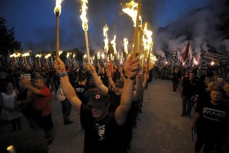 Golden Dawn supporters lift torches as they take part in a ceremony in Thermopylae, outside Athens, Greece, September 5, 2015. REUTERS/Fotis Plegas G.