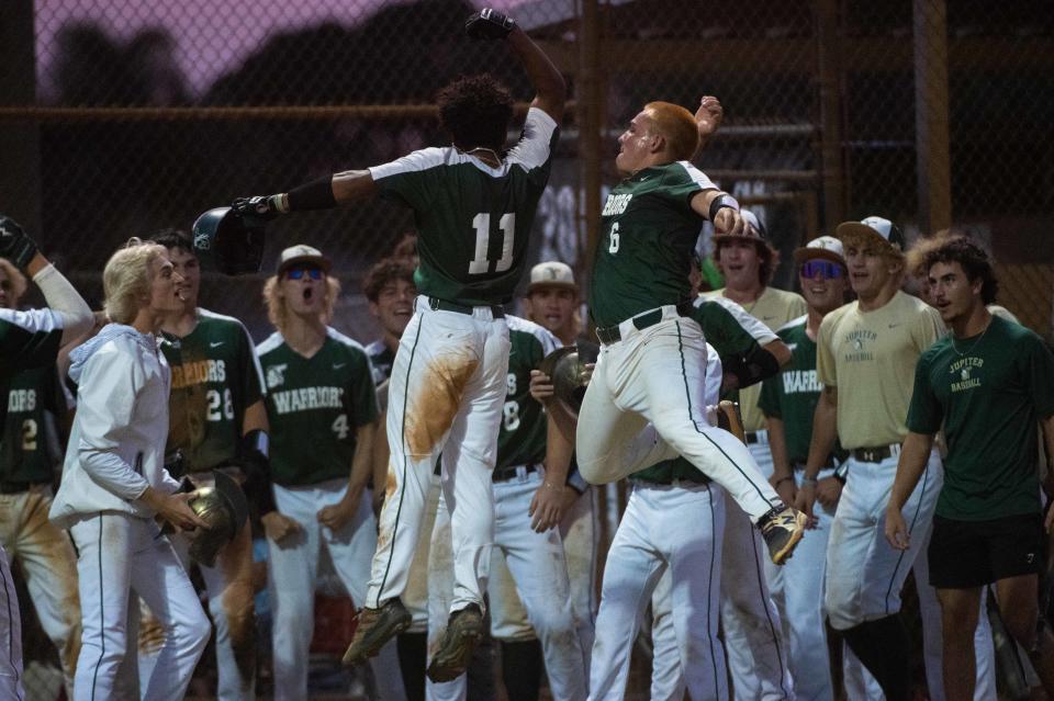 Palm Beach Central outfielder Jayden Arroyo (11) celebrates a home run at the bottom of the third with teammate Ryan Schulman (6) during the District 11-7A championship baseball game between host Jupiter and Palm Beach Central on Thursday, May 4, 2023, in Jupiter, Fla. Final score, Jupiter, 11, Palm Beach Central, 3.