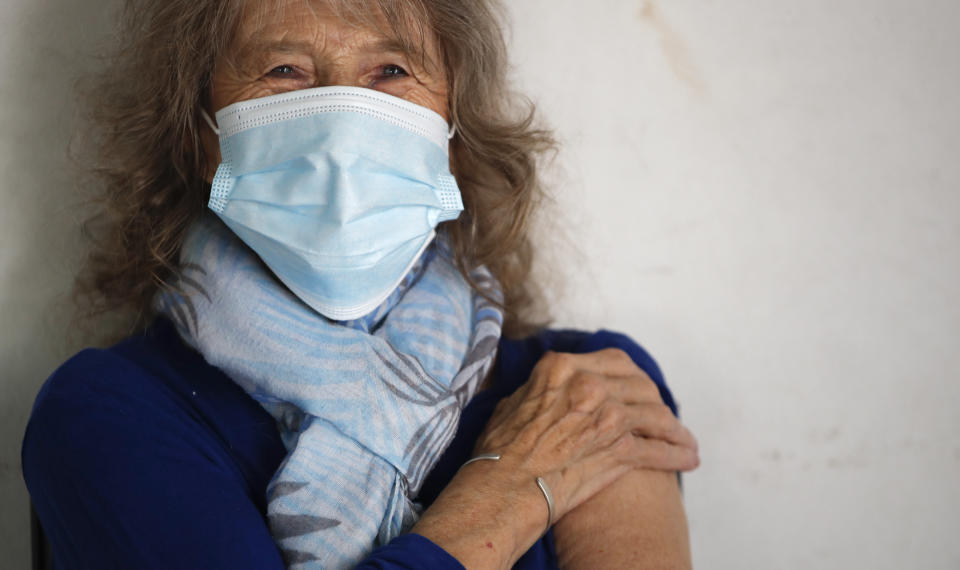 Carmela Corleto smiles after getting her first shot of the AstraZeneca vaccine for COVID-19 at a vaccination center in Almirante Brown, Argentina, Friday, April 23, 2021. (AP Photo/Natacha Pisarenko)