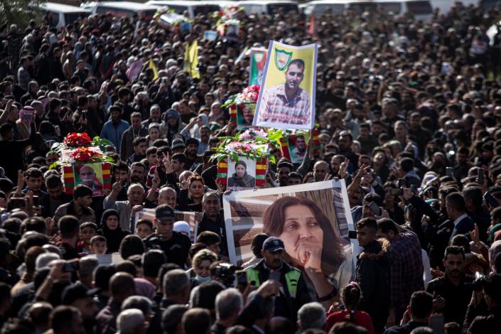 Syrian Kurds attend a funeral of people killed in Turkish airstrikes in the village of Al Malikiyah , northern Syria (AP)