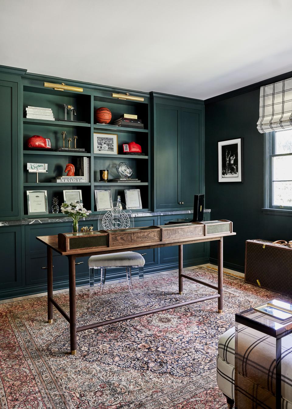 Roxy wanted her husband’s office to pop, so she painted it in dark green and had a leather-and-burl desk custom-made by L.A.’s 4th Period Woodshop. “During COVID I’ve gotten excited for Zoom calls because I have this awesome backdrop,” says Nicolas, whose acrylic desk chair is etched with the House of Bijan crest.