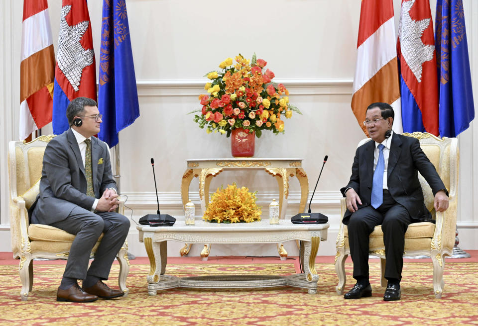 In this photo provided by Cambodia's Government Cabinet, Cambodian Prime Minister Hun Sen, right, and Ukrainian Foreign Minister Dmytro Kuleba, left, hold a talk during a welcome meeting at Peace Palace in Phnom Penh, Cambodia, Wednesday, Nov. 9, 2022. (Kok Ky/Cambodia's Government Cabinet via AP)