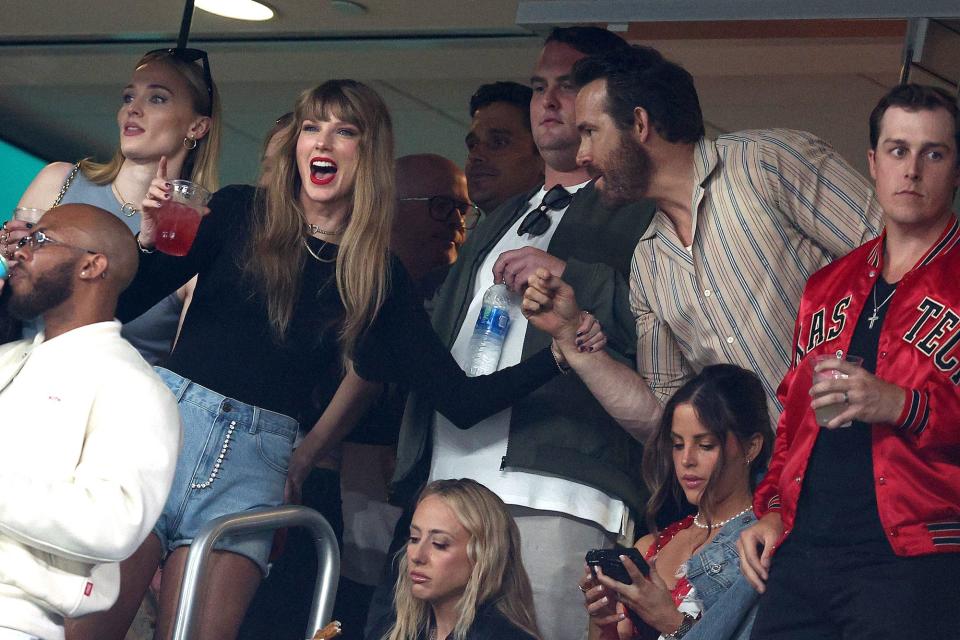 Taylor Swift and Ryan Reynolds interact at an NFL game on October 1, 2023.