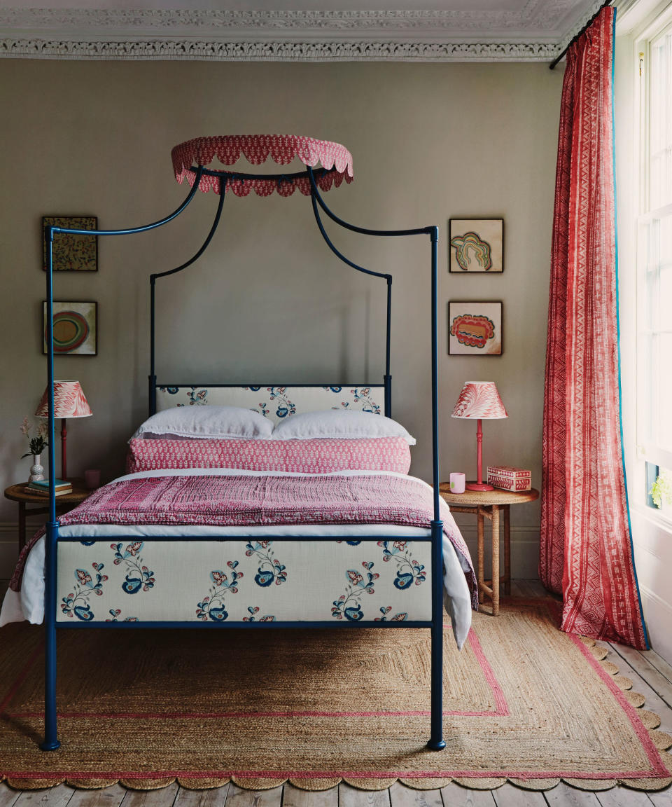 <p> Here, the prettiest of pinks has been introduced into this serene neutrally-decorated&#xA0;guest bedroom&#xA0;with a lightness of touch. From the scalloped crown on the bed, the bolster, quilt, artwork, lampshade and curtains to the pink line detail in the natural woven rug, these pinks all work together to create a coherent feel without overwhelming the room.&#xA0; </p> <p> The painted bed adds an elegant structure at the center of the scheme in a vibrant contrast teal blue. And, just as with the pink touches, elements of pattern sit together harmoniously without overpowering. &#xA0;The eye is invited to dance across the space taking in all these delightful elements. Who wouldn&apos;t wish to stay here as a guest for the weekend?&#xA0; </p>