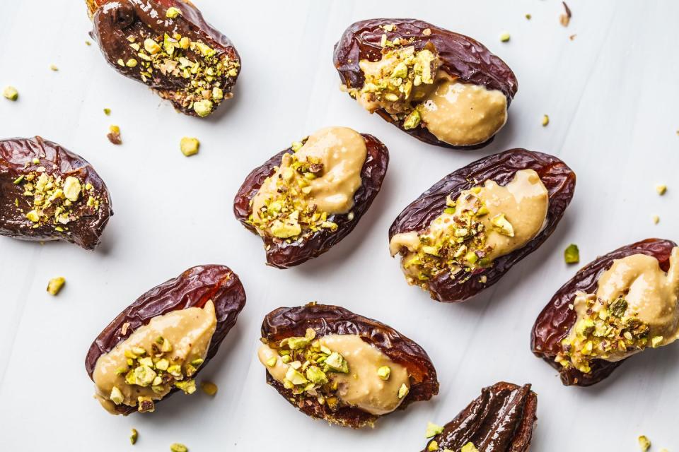 eid al fitr food dates stuffed with peanut butter and pistachios on a white background