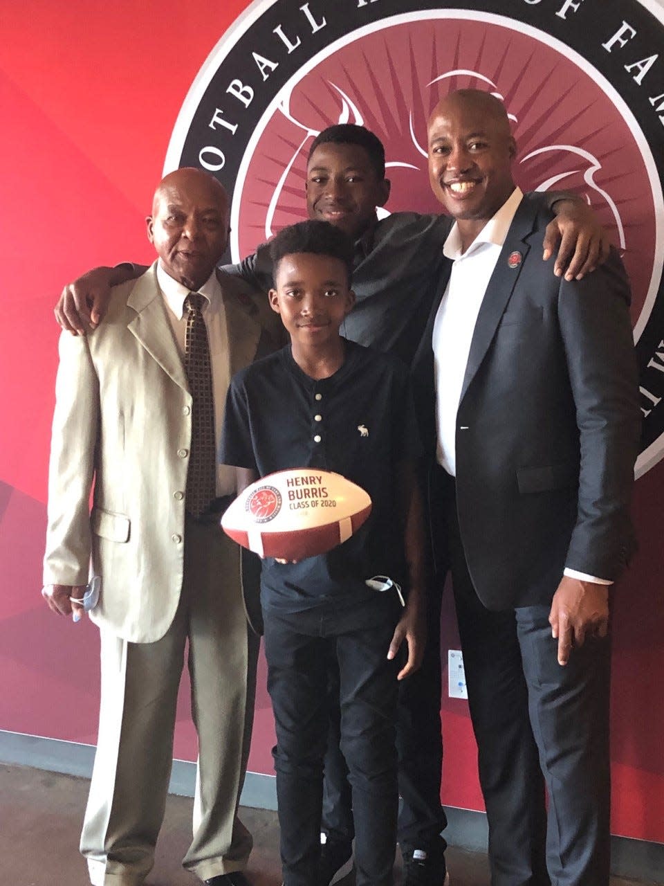Canadian Football Hall of Famer Henry Burris shown with his father Henry Sr. and his sons Armand and Barron.