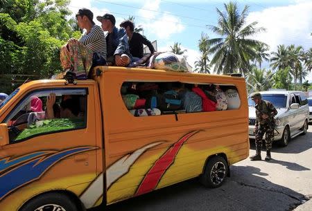 A government soldier inspects a vehicle at a checkpoint along a main highway in Pantar town, Lanao del Norte, after residents started to evacuate their hometown of Marawi city, southern Philippines May 24, 2017. REUTERS/Romeo Ranoco